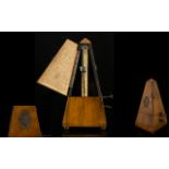 Antique Maelzel Metronome Of typical pyramid form in walnut case, height, 9 1/4 inches,