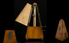 Antique Maelzel Metronome Of typical pyramid form in walnut case, height, 9 1/4 inches,