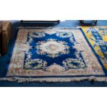 Oriental Style Wool Rug - of traditional floral design on taupe ground with wide cobalt blue border