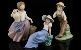 Three Nao Figures comprising Nao large figure of a young girl carrying a water bucket and water jar,