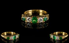 18ct Emerald And Diamond Ring Alternating emerald and diamonds in a scroll mount, fully hallmarked,