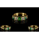 18ct Emerald And Diamond Ring Alternating emerald and diamonds in a scroll mount, fully hallmarked,