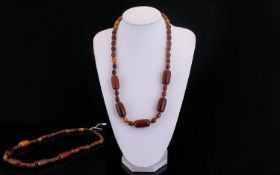 Early 20th Century Stand Of Amber Coloured Beads Consisting of five cherry amber/ butterscotch large