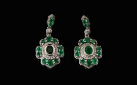 Emerald and Zircon Drop Earrings, each pendant drop having an oval cut emerald, bezel set,