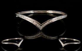 A 9ct White Gold Hinged Bangle Wishbone form set with 25 round cut diamonds, fully hallmarked, 10.