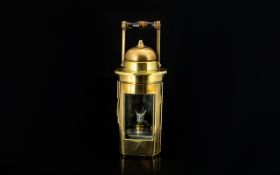 Antique Brass Lamp Of typical, cylindrical form with domed top and hinged, glazed door to front.