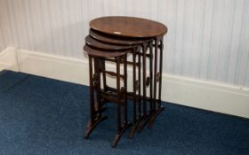 A Nest Of Four Walnut Tables Circa early 20th century with inlaid work to oval top,