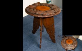 Anglo Indian Carved Occasional Table Raised on carved, tapering quatrefoil legs,