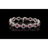 Ruby and White Topaz Cluster Line Bracelet, 30cts, comprising fourteen round cut rubies of rich