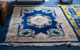 Oriental Style Wool Rug - of traditional floral design on taupe ground with wide cobalt blue