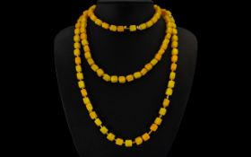 Antique Long Hand Knotted Amber Coloured Bead Necklace Comprising cube form beads of rich milky