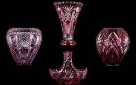 A Collection Of Four Cut Glass Vessels All in cranberry tone glass to include miniature basket,