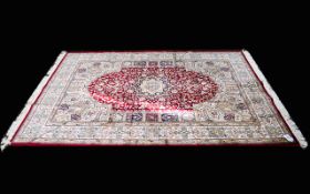 A Very Large Woven Silk Carpet Keshan rug with red ground and traditional Middle Eastern floral and