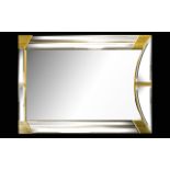 Gold Tone Modernist Mirror Of rectangular form, bevelled glass,