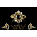 18ct Gold Sapphire And Diamond Cluster Ring The central blue sapphire surrounded by round cut