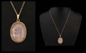 Ladies 9ct Gold Single Rose Quartz Set Pendant With Attached 9ct Gold Chain The cabochon cut rose