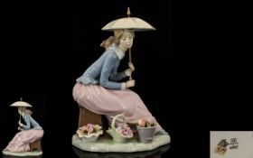 Nao by Lladro Handpainted Porcelain Figure 'Girl with Parasol' seated with baskets of flowers to