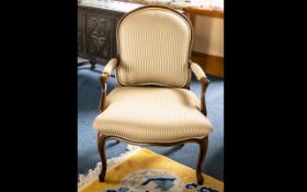 Mahogany Finish Open Arm Chair - padded back rest and seat, raised on short cabriole legs.