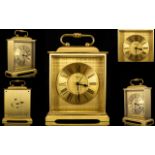 A Brass Travelling Clock Comprising gilt chapter dial with Roman numerals, marked to dial Suisse,