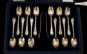 A Boxed Set of 12 Silver Teaspoons and Matching Sugar Nips. In Unused Condition. Please See Photo.