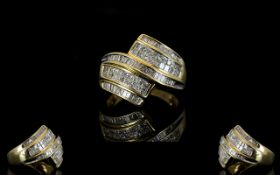 14ct Gold Diamond Dress Ring Comprising seven rows of baguette and princess cut diamonds,