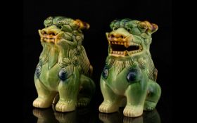 A Pair Sancai Glazed Modern Foo Dogs Each with open mouths in traditional green,