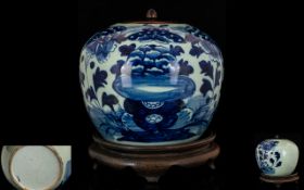 Antique Jar And Cover Blue and white jar of globular form depicting blossom, with wooden lid, raised