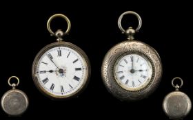 Two Ladies Open Faced Silver Fob Watches Each with white enamel dials and Roman numerals,