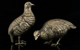 A Pair Of Cast Metal Bird Figures Silver tone metal with distressed/aged patina in the form of two