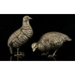 A Pair Of Cast Metal Bird Figures Silver tone metal with distressed/aged patina in the form of two