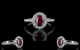 18ct White Gold Ruby And Diamond Cluster Ring Central ruby surrounded by round modern brilliant cut