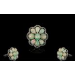 Opal Cluster Ring, comprising six pear cut and two round cut opal cabochons, closely set around an