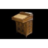 Early 20th Century Davenport Comprising carved rosette front panel with a bank of four drawers and