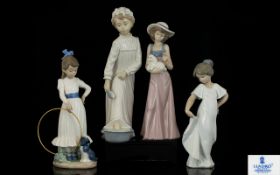 A Collection Of Four Nao Figurines To include young girl with hoop - 9.