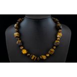 Tiger Eye Fancy Cut Bead Necklace, a strand of smoothly faceted cuboid tiger eye beads,