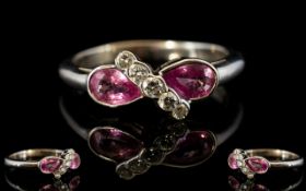 18ct White Gold Pink Sapphire And Diamond Ring Two pear shaped sapphires set between a row of