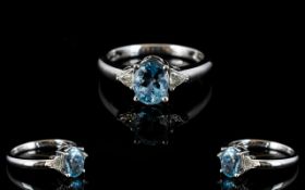 Platinum Aquamarine And Diamond Set Ring Central oval cut aquamarine set between to triangular cut