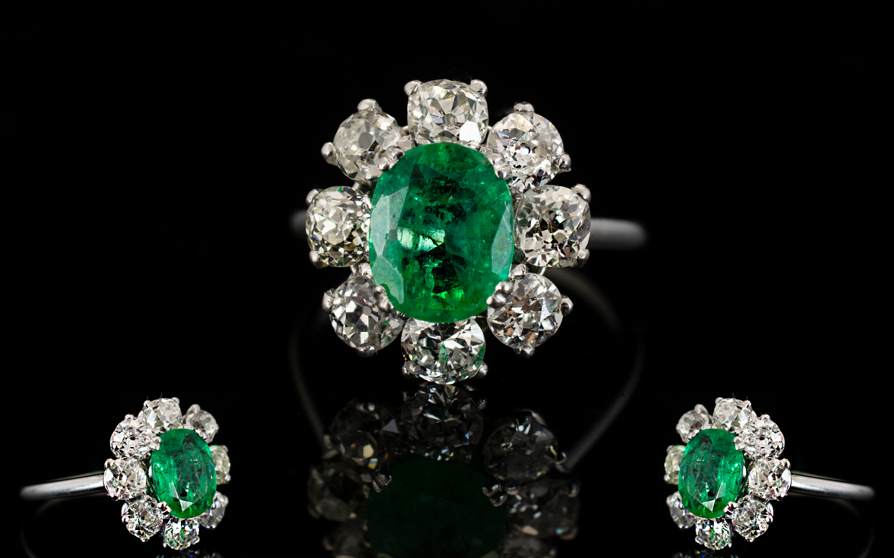 18ct White Gold Diamond Emerald And Diamond Cluster Ring Set with oval cut Emerald surrounded by 8