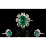 18ct White Gold Diamond Emerald And Diamond Cluster Ring Set with oval cut Emerald surrounded by 8