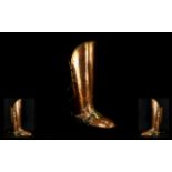 A Novelty Planished Copper And Brass Stick Stand In the Form Of A Military Boot Marked 'Lombard