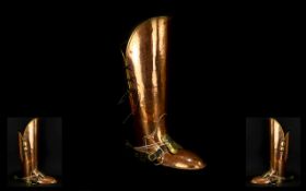 A Novelty Planished Copper And Brass Stick Stand In the Form Of A Military Boot Marked 'Lombard