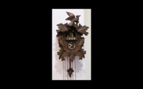 A German Black Forest Cuckoo Clock Of traditional form,