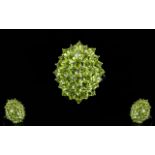 Peridot Large Oval Cluster Ring, a large cluster of oval and round cuts of peridot totalling 6.