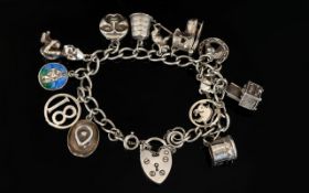 Silver Curb Bracelet Loaded with 13 Silver Charms, All Marked for Silver From The 1960's.