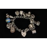 Silver Curb Bracelet Loaded with 13 Silver Charms, All Marked for Silver From The 1960's.