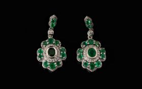 Emerald and Zircon Drop Earrings, each pendant drop having an oval cut emerald, bezel set, initially