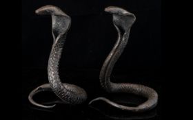 A Pair Of Antique Case Metal Cobras. In Typical Sprayed Hood Form. Height 18cm. Please See