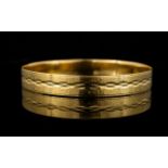 An 18ct Gold Italian Bangle Yellow gold bangle with textured finish and etched diamond pattern.