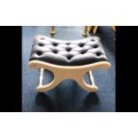 X - Framed Concave Footstool - royal blue leather button rest on white painted frame.