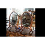 A Pair Of 19th Century Toilette Mirrors oval mirror with bevelled glass on turned supports with